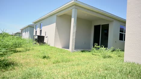 unsold housing in south florida, abandoned yard, unmaintained despite hoa