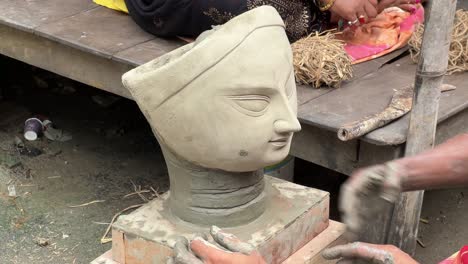 the making of a durga idol face with clay and hay for the kolkata's one of the greatest festival, durga puja.