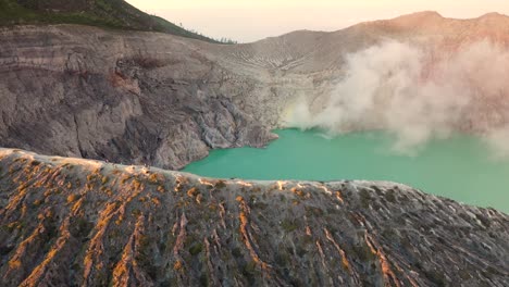 espectacular vista aérea de un creador en el volcán kawah ijen con lago de azufre turquesa al amanecer