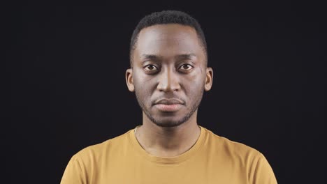 close-up portrait of unhappy and sad african young man.