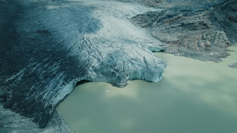 icebergs falling in the water while a glacier is melting due to climate change