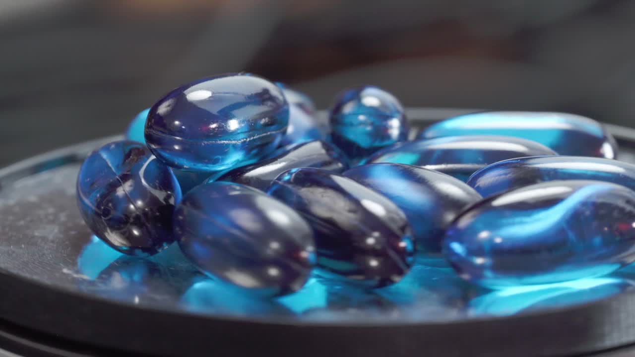 Blister pack with medicine pills rotating slowly on studio background, product shot