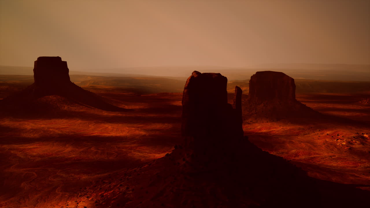 Monument Valley Sunset: Arid Landscape of Red Rock Buttes