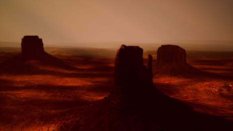 monument valley sunset: arid landscape of red rock buttes