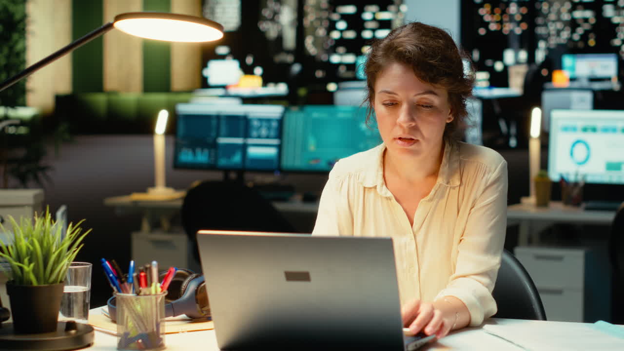 Vertical Video Dedicated manager in a corporation stays after hours to focus on budgeting