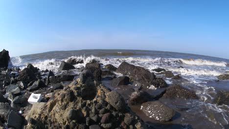 4k fisheye, a rocky beach by the waves during the day