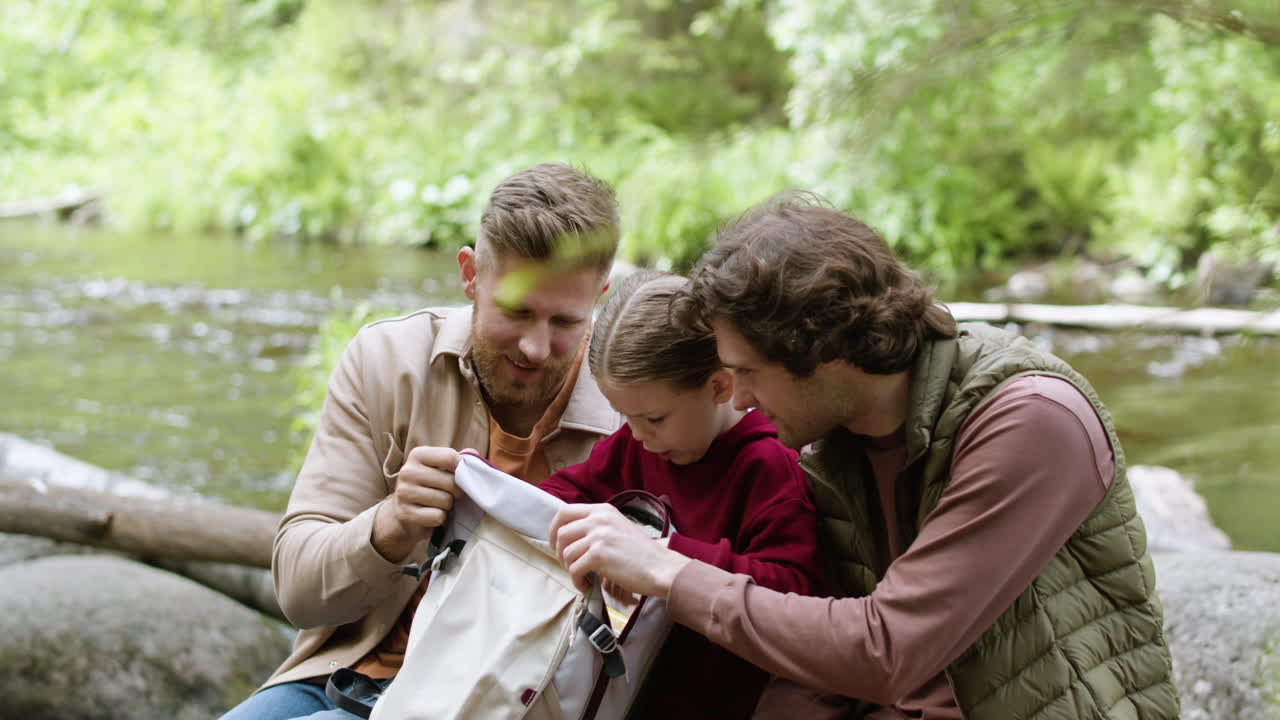 Family enjoying nature near the river