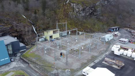 electric high voltage transformer and distribution station outside hydroelectric powerplant at dalekvam norway - bkk eviny company - orbiting aerial