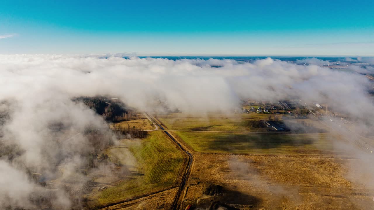 Soft clouds slowly sweep across rural Jaunolaine Latvia during bright spring day