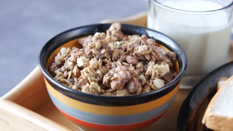 healthy breakfast with granola, milk, and bread