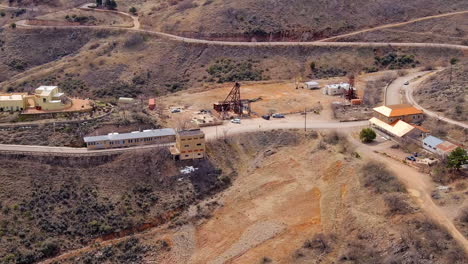 Small-mining-town-with-industrial-buildings,-aerial-view