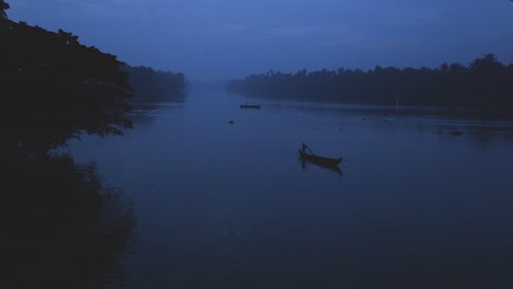 Sunrise-in-backwaters,fishermen-arriving-shore,up-angle-view