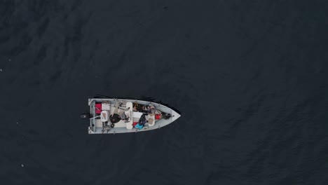 aluminum boat sitting in the ocean on a gloomy day