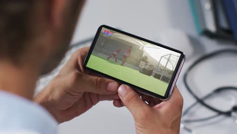 Composite-of-male-doctor-watching-hockey-match-on-smartphone