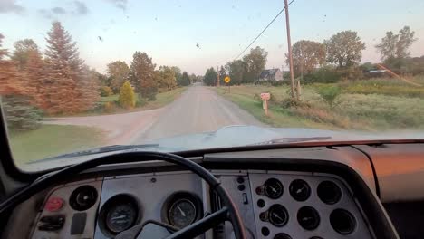 POV-driving-old-dump-truck-down-bumpy-dirt-road-in-rural-America