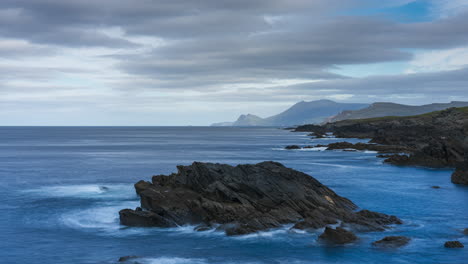 timelapse of rugged coastline with moving clouds on sunny day in cloughmore bay in achill island in county mayo along the wild atlantic way