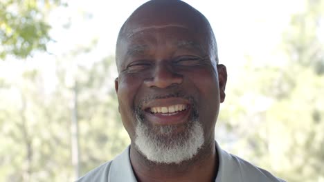 Retrato-De-Un-Feliz-Hombre-Afroamericano-Mayor-En-Una-Terraza-Soleada,-Cámara-Lenta