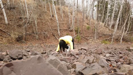 girl climbing rocks walking up a hill in north minnesota