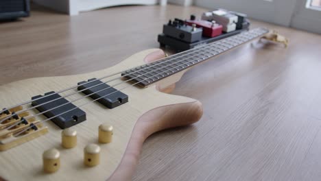 close up dolly of a bass guitar and effect pedals