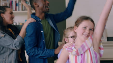 happy multiracial family dancing at home having fun enjoying dance celebrating exciting weekend together