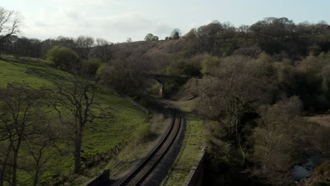 low aerial flyover of heritage railway line in rural north york moors, england