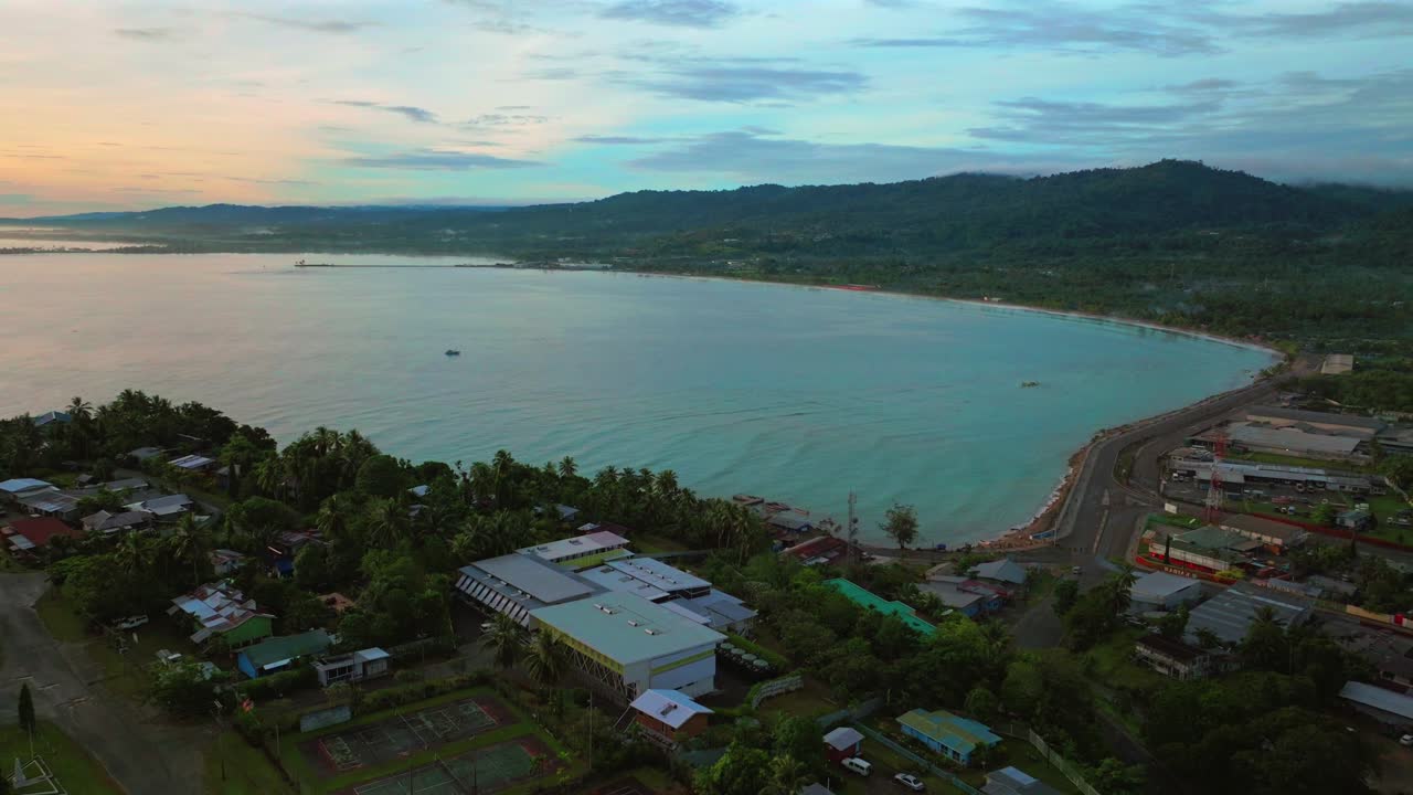 Vibrant sunrise morning Meni Beach Wewak Hill port peninsula morning summer dry season fog Wewak costal town aerial drone Papua New Guinea PNG Dogreto Bay panoramic ocean view Boram Road backwards