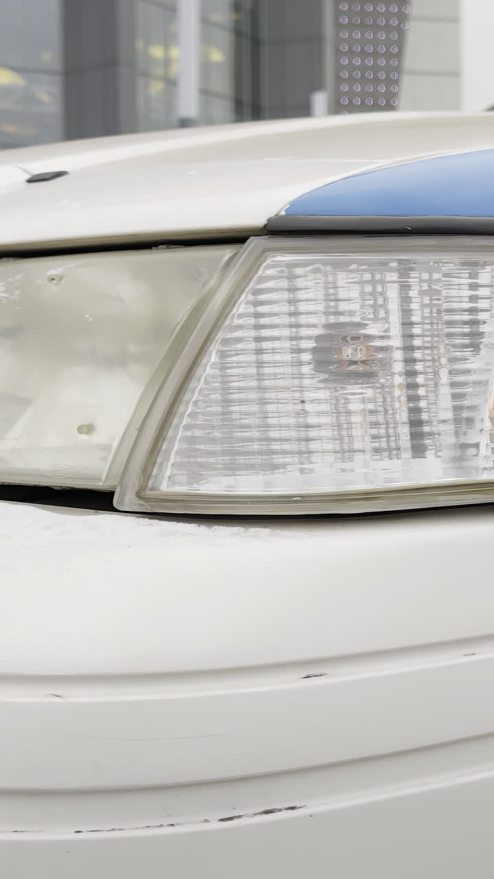 Car Headlight Covered in Snow