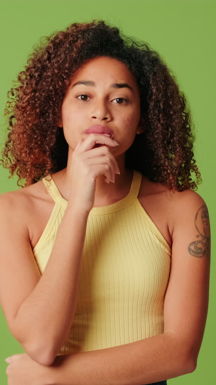 Young Woman Thinking and Shrugging with Uncertainty