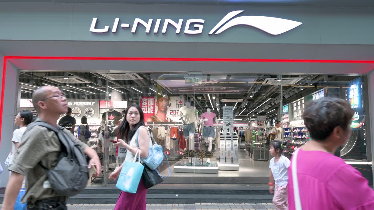 Pedestrians walk past Li-Ning, the Chinese sportswear and sports equipment company, in Hong Kong, China.