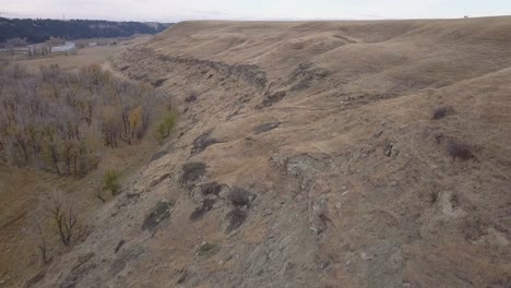 Wild-game-trails-on-dry-prairie-rocky,-eroded-river-valley-hillside