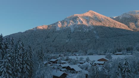 Traditional-old-village-in-white-snow-winter-landscape-near-Lake-Schliersee-and-Spitzingsee