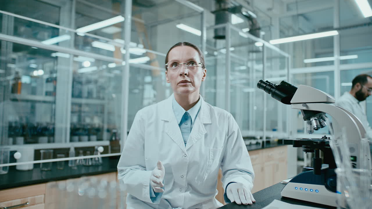 Female Scientist Presenting Experiment Results in Research Laboratory
