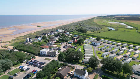 High-above,-video-footage-reveals-the-tranquility-of-Anderby-Creek,-a-beautiful-and-quiet-natural-beach-along-the-Lincolnshire-coast-in-the-town-of-Anderby