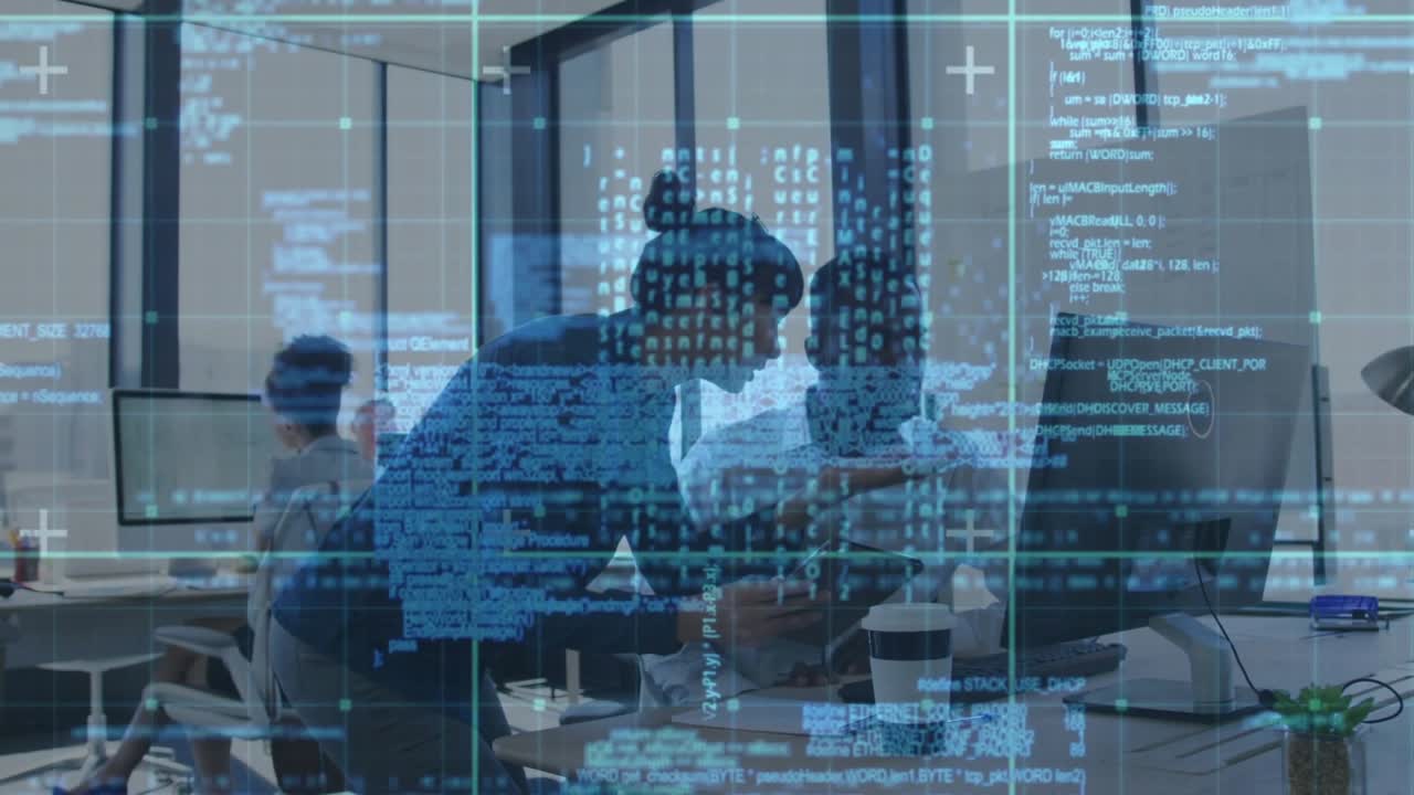 Standing woman leaning over seated man using tablet starting code overlay reviewing code on monitor