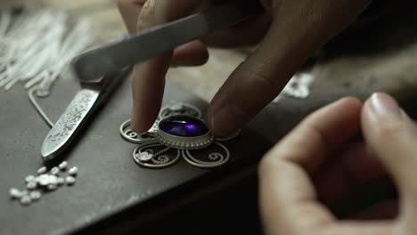 jeweler at work in jewelry. desktop for craft jewelry making with professional tools. close up view of tools. thailand.