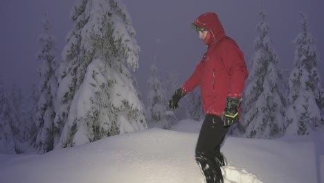 male person jumping into deep snow during night