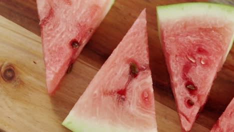 Slices-of-watermelon-arranged-on-chopping-board