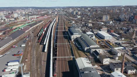 aerial: panorama of train railroad in vilnius with tracks and buildings