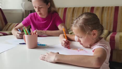 mother and daughter drawing together