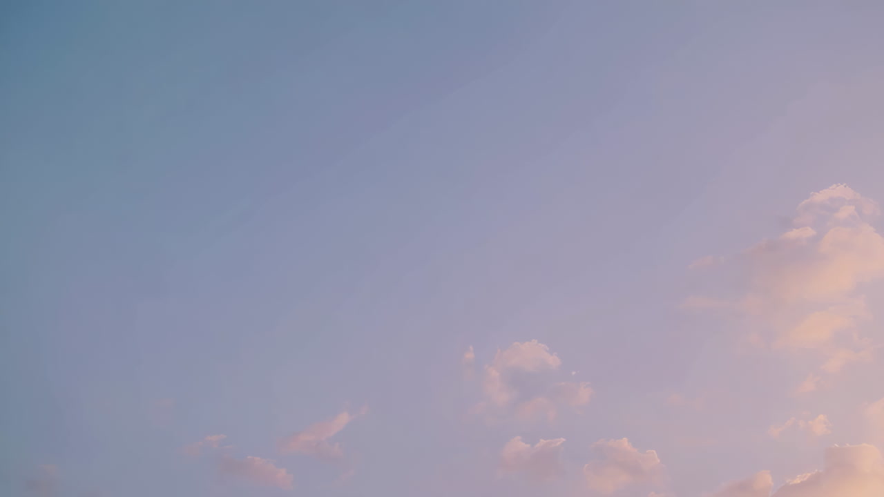 Soft Pastel Gradient Sky with Clouds at Sunset or Sunrise