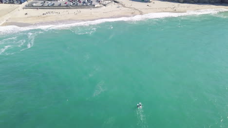 Kayakistas-Disfrutando-De-Las-Aguas-Cristalinas-En-Portreath,-Cornualles,-Inglaterra--Toma-Panorámica-Aérea