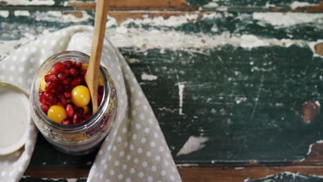 yogurt with pomegranates and golden berries in glass jar 4k