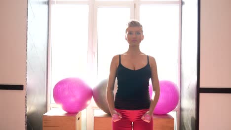 young pregnant woman doing exercises on a fitness ball at home young pregnant woman doing exercises on a fitness ball in her cozy living room promoting relaxation and wellbeing during pregnancy