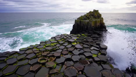 dynamic waves crashing on hexagonal basalt columns at giant's causeway