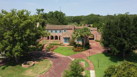 casa feliz - historic spanish-style brick mansion in winter park, florida. sideways drone shot