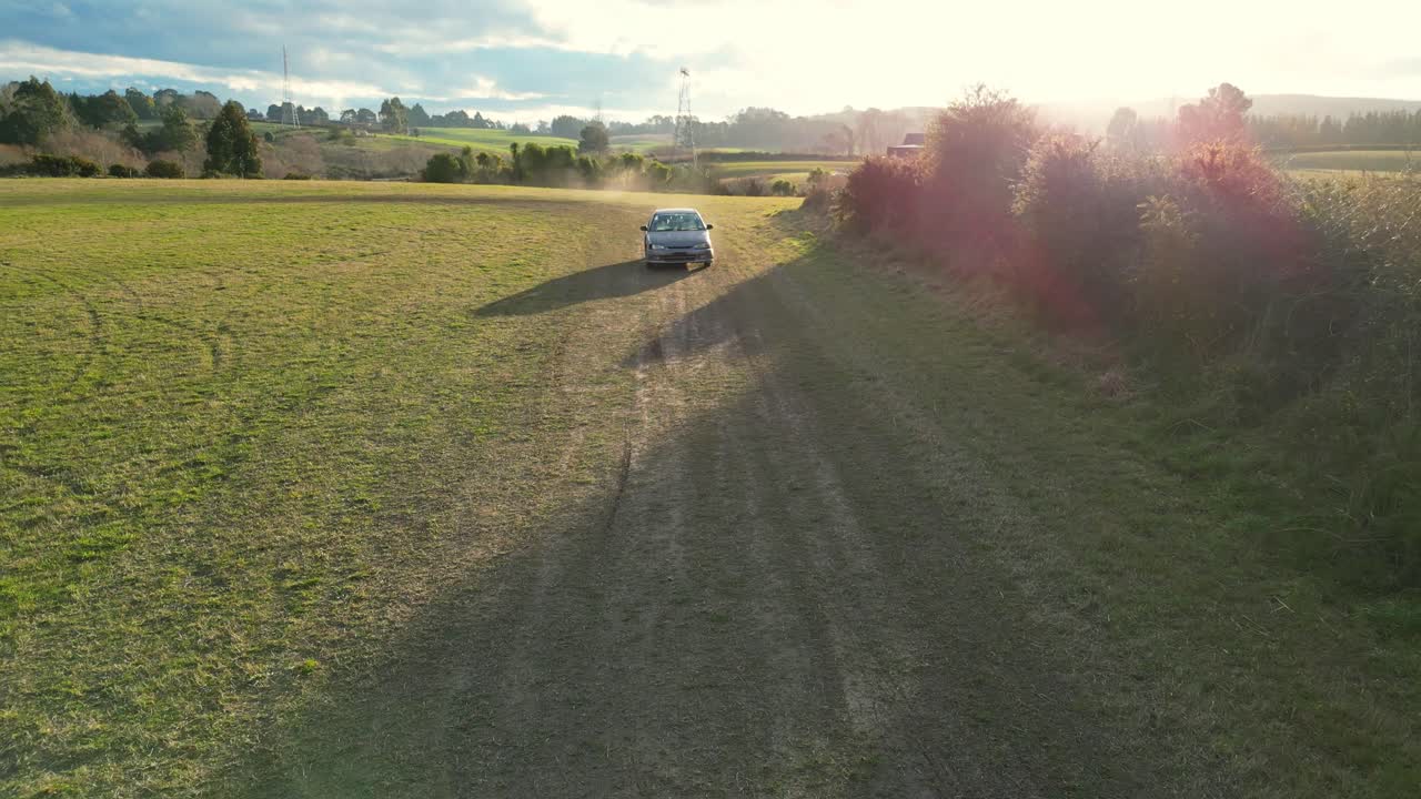 High-Speed Drone follow shot of an old car Racer at Golden Hour in a field – Canterbury, New Zealand.