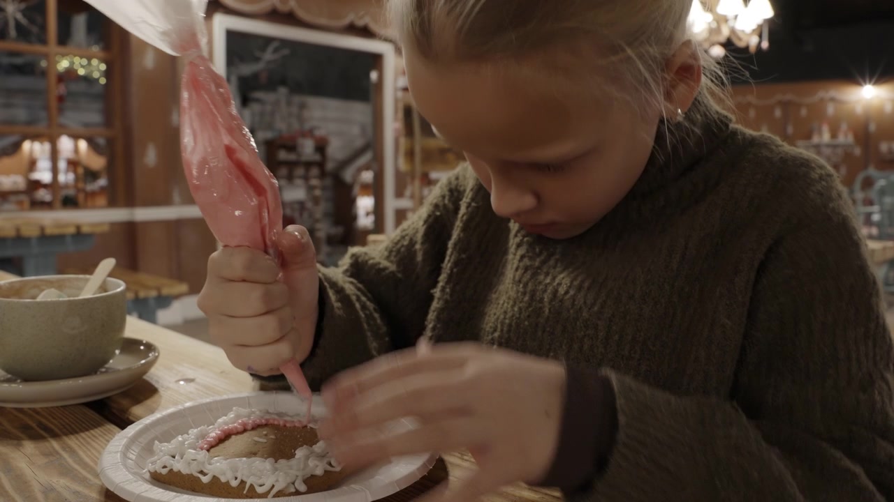 Young Girl Decorating Gingerbread Cookie with Icing
