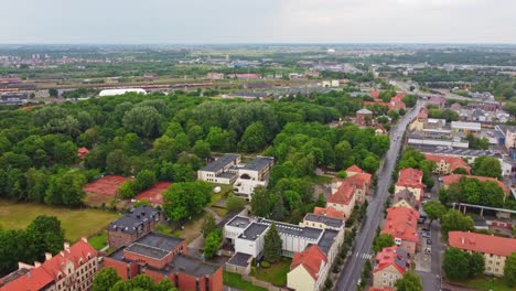 Klaipeda-aerial-drone-shot-flying-above-townscape-surrounded-by-trees,-Baltics