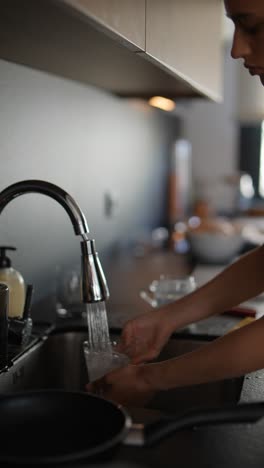 woman washing dishes in a modern kitchen