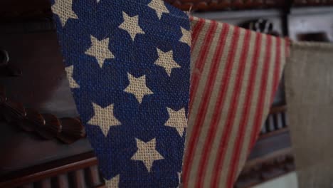 stars and stripes flags hanging on wooden fireplace mantle